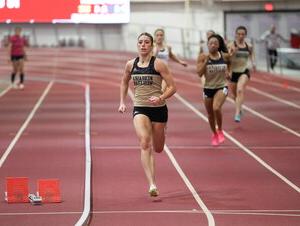 Bella Hogue runs on a track. 